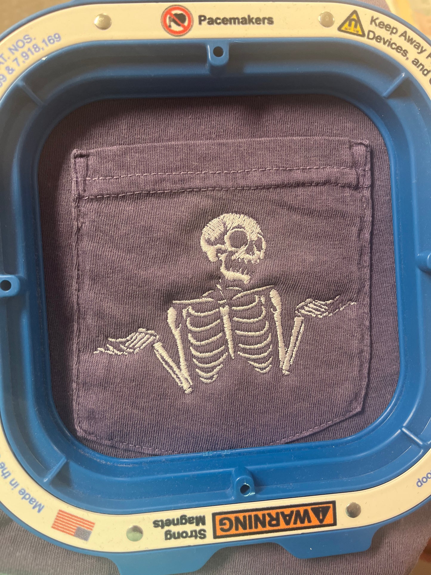 Embroidered Shrugging Skeletons Tee in Grape